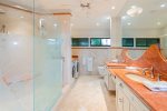 Enjoy the added space of twin vanities boasting custom granite countertops